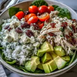 Bright Mediterranean Tzatziki Chicken Salad featuring juicy cherry tomatoes, tangy feta, and briny Kalamata olives, perfect for a light gluten-free dinner.