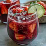 Vibrant Dragon Drink Refresher with creamy coconut milk and fresh dragon fruit, served over ice in a tall glass.