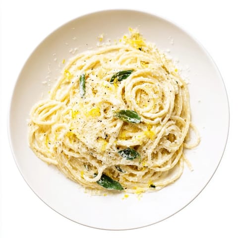 Bright lemon ricotta pasta tossed with olive oil and garlic, served warm in a shallow bowl for lunch.