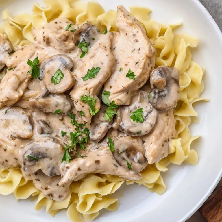 Hearty Chicken and Mushroom Stroganoff with savory meat and earthy mushrooms in a rich, velvety sauce, ideal for serving family-style with crusty bread.